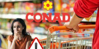 Un carrello della spesa ed il logo Conad